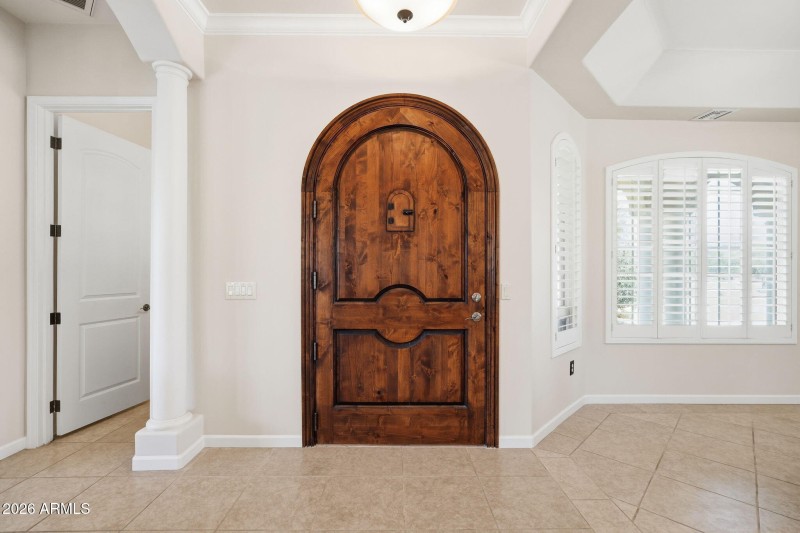 Grand Entry with Custom Arched Wood Door