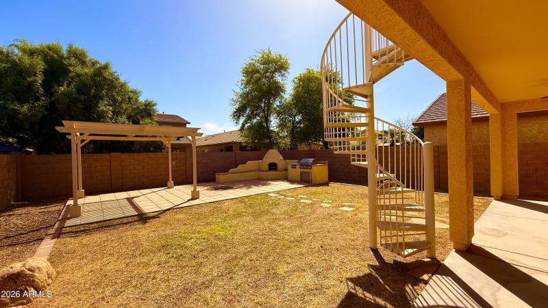 Large backyard with outdoor kitchen