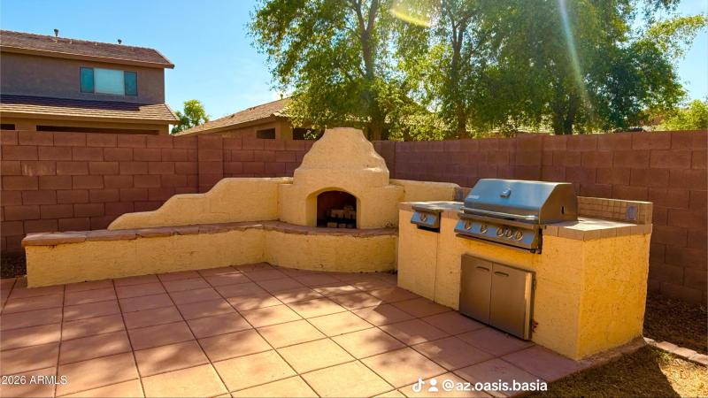 Outdoor kitchen with fireplace and BBQ