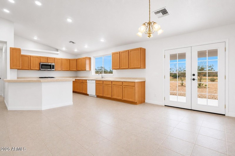 vacant open concept kitchen and dining r