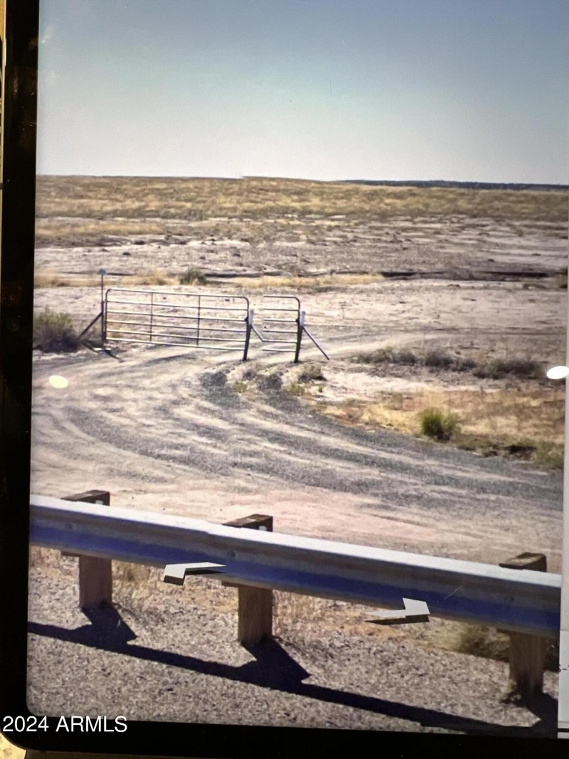 Gate to road leading to property