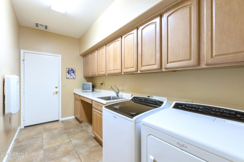 Laundry with sink and cabinets