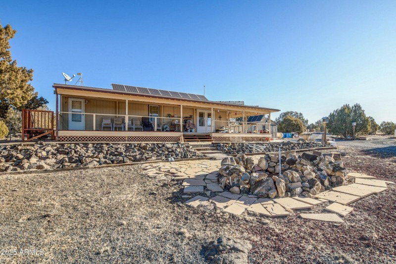 Front of home with massive fire pit