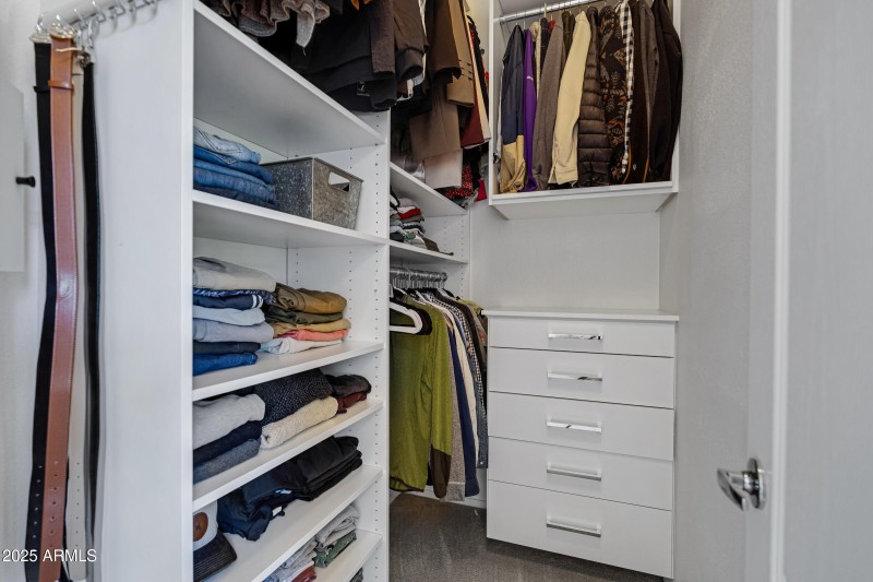 Primary bedroom walk in closet
