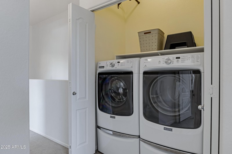 Utility closet next to primary bedroom