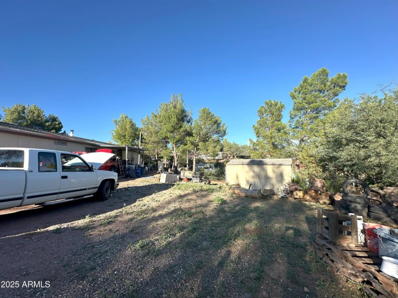 side yard looking towards the carport an