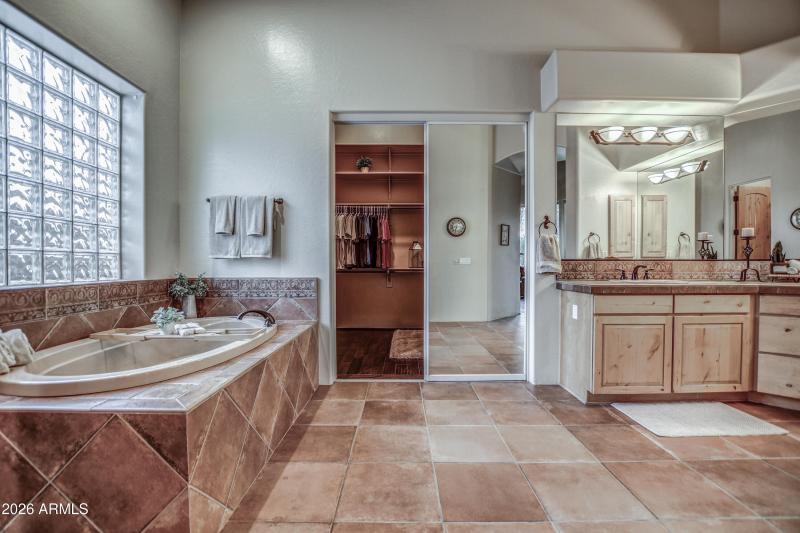 Primary bathroom tub and closet entry