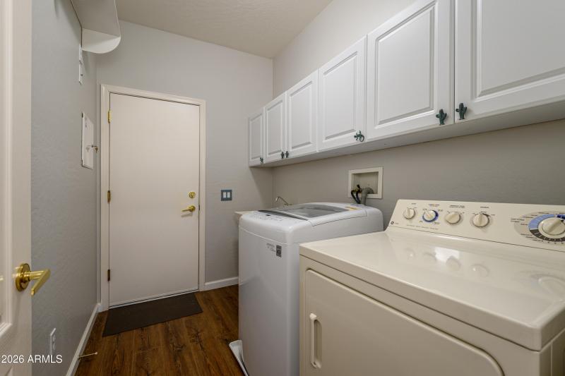 Fabulous Laundry area with cabinets